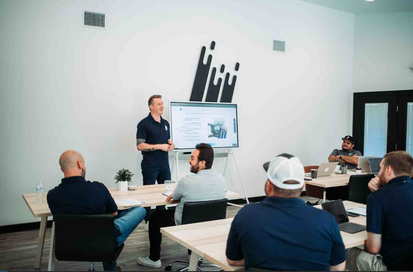 Steven leading a ResiBrands training session with owners in the office.